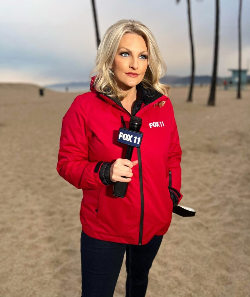 Picture of a Los Angeles news reporter on-location with light blonde hair, cut mid-length, and styled.